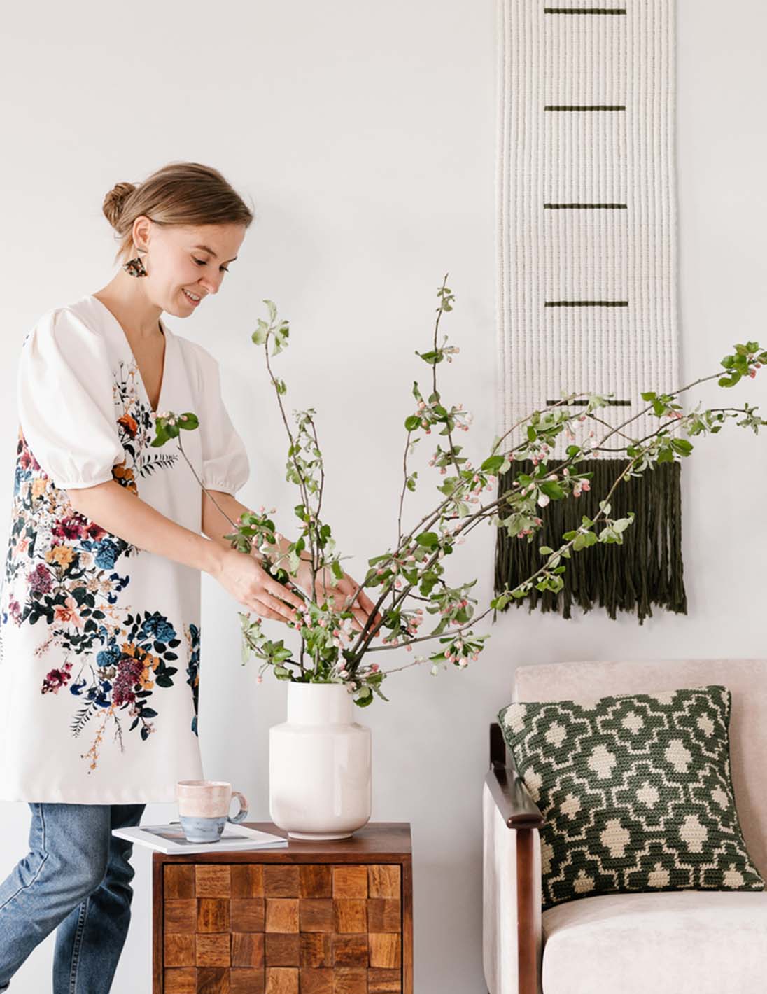 woman arranging flowers in a vase