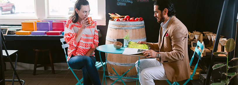 A couple sips coffee at a coffee shop